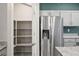 Bright kitchen featuring a pantry, stainless steel fridge, and ample counter space at 393 Mullen Ave, Henderson, NV 89044