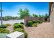 Gravel side yard with manicured shrubbery and gated access for outdoor living at 393 Mullen Ave, Henderson, NV 89044