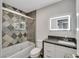 Beautiful bathroom with a tiled shower, decorative mirror, and granite countertop, offering a luxurious and stylish space at 4143 Chela Cir, Las Vegas, NV 89120