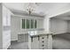This is a walk-in closet with natural light, custom shelving, and granite top island at 4143 Chela Cir, Las Vegas, NV 89120