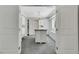 Spacious walk-in closet with custom shelving, an island, a carpet flooring, and a chandelier at 4143 Chela Cir, Las Vegas, NV 89120
