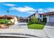 View of the home featuring a modern driveway, red tile roof, and desert landscaping at 4143 Chela Cir, Las Vegas, NV 89120