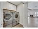 This laundry room features modern appliances and opens to the living room with a fireplace at 4143 Chela Cir, Las Vegas, NV 89120