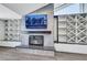 Inviting living room features a fireplace, television and custom built in shelving at 4143 Chela Cir, Las Vegas, NV 89120