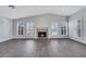 Well-lit living room showcasing tile floors, a cozy fireplace, and plantation shutters at 4143 Chela Cir, Las Vegas, NV 89120