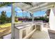Outdoor kitchen has granite countertops, a bar area and a built in sink at 4143 Chela Cir, Las Vegas, NV 89120