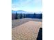 Mountain views enhance this desert landscaped backyard with brick paved patio and privacy wall at 42 Late Harvest Ave, Pahrump, NV 89060