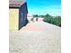 Expansive backyard with desert landscaping features brick paved patio, lush privacy hedges, and ample space at 42 Late Harvest Ave, Pahrump, NV 89060