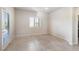 Bright bedroom with neutral paint, tile floors, and sliding glass door for ample natural light at 42 Late Harvest Ave, Pahrump, NV 89060
