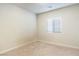 This bedroom features a neutral palette, carpeted flooring, and a bright window at 42 Late Harvest Ave, Pahrump, NV 89060