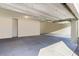 Bright and spacious three-car garage featuring freshly painted walls and a clean, concrete floor at 42 Late Harvest Ave, Pahrump, NV 89060