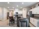Well-lit kitchen with island seating, white cabinets, and modern appliances at 42 Late Harvest Ave, Pahrump, NV 89060