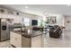 Open-concept kitchen with stainless steel appliances, granite countertops, and seamless flow to living area at 42 Late Harvest Ave, Pahrump, NV 89060