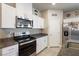 Well-equipped kitchen with stainless steel appliances, white cabinets, and granite countertops at 42 Late Harvest Ave, Pahrump, NV 89060