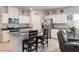 Stylish kitchen featuring white cabinetry, granite counters, and stainless steel appliances at 42 Late Harvest Ave, Pahrump, NV 89060