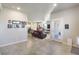 Open-concept living room with tile flooring, neutral walls, and seamless flow to the kitchen at 42 Late Harvest Ave, Pahrump, NV 89060