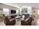 Inviting living room with comfortable seating, large windows, and a ceiling fan at 42 Late Harvest Ave, Pahrump, NV 89060