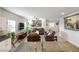 Open-concept kitchen and living room with granite countertops, and neutral decor at 42 Late Harvest Ave, Pahrump, NV 89060
