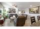 Inviting living room with tiled flooring, comfortable seating, and decorative wall hangings at 42 Late Harvest Ave, Pahrump, NV 89060
