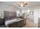 Spacious main bedroom with a ceiling fan, carpet, and a connecting bathroom at 42 Late Harvest Ave, Pahrump, NV 89060