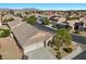 An aerial view of a single-story home featuring a three-car garage and desert landscaping at 4308 Brazil Palm Ct, North Las Vegas, NV 89032