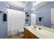 Bathroom with large mirror and a shower with white curtain at 4308 Brazil Palm Ct, North Las Vegas, NV 89032