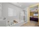 Well lit bathroom features a walk in shower and a soaking tub with tile flooring throughout at 4308 Brazil Palm Ct, North Las Vegas, NV 89032