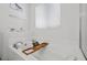 Bright bathroom features a soaking tub, and an inset shelf for decor and storage at 4308 Brazil Palm Ct, North Las Vegas, NV 89032