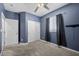 Bedroom features neutral carpet, blue walls, closet, and natural light at 4308 Brazil Palm Ct, North Las Vegas, NV 89032
