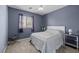 Charming bedroom with neutral walls, carpet, ceiling fan and a stylish patterned bedspread at 4308 Brazil Palm Ct, North Las Vegas, NV 89032