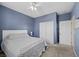 Well lit bedroom features a large closet, soft carpeting and a ceiling fan for added comfort at 4308 Brazil Palm Ct, North Las Vegas, NV 89032