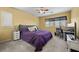 Cozy bedroom features plush carpet, ample natural light, a ceiling fan and a small workstation at 4308 Brazil Palm Ct, North Las Vegas, NV 89032