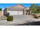 Charming single-story home featuring a three-car garage and desert landscaping at 4308 Brazil Palm Ct, North Las Vegas, NV 89032