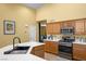 Modern kitchen featuring white countertops, stainless steel appliances, and wood cabinetry at 4308 Brazil Palm Ct, North Las Vegas, NV 89032
