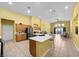 Open kitchen with a spacious island, stainless steel appliances, and tile flooring leading to the dining area at 4308 Brazil Palm Ct, North Las Vegas, NV 89032