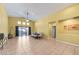 Open-concept living and dining area with tile floors and sliding glass doors at 4308 Brazil Palm Ct, North Las Vegas, NV 89032