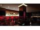 Modern bar area featuring stylish seating, illuminated display shelves, and red lighting accents throughout at 4381 W Flamingo Rd # 1508, Las Vegas, NV 89103