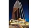 Exterior shot of Palms Place at night, showcasing the building's illuminated facade and modern design at 4381 W Flamingo Rd # 1508, Las Vegas, NV 89103