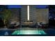 Relaxing hot tub area with an outdoor fireplace, comfortable seating, and ambient lighting at 4381 W Flamingo Rd # 1508, Las Vegas, NV 89103