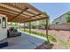 Expansive backyard with a covered patio, lush green grass, and mature trees, perfect for outdoor entertaining at 459 Kelsford Dr, Las Vegas, NV 89123