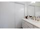 Bathroom featuring a single sink vanity, sliding mirror closet doors, and faucet at 459 Kelsford Dr, Las Vegas, NV 89123