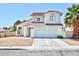 A two-story home features low maintenance landscaping, a tile roof and a two-car garage at 459 Kelsford Dr, Las Vegas, NV 89123