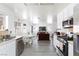 The open kitchen connects to the living room with stainless steel appliances and a dining table at 459 Kelsford Dr, Las Vegas, NV 89123
