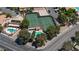 Overhead shot of community tennis courts, swimming pool, and landscaping next to luxury homes in a neighborhood at 459 Kelsford Dr, Las Vegas, NV 89123