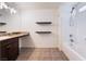 Bathroom featuring floating shelves, granite vanity and shower-tub combination at 4610 Lime Straight Dr, Las Vegas, NV 89115