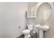 A modern half-bathroom with a pedestal sink and neutral walls at 4610 Lime Straight Dr, Las Vegas, NV 89115