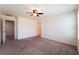 Large bedroom with plush carpets, fan, bright white walls and ensuite entrance at 4610 Lime Straight Dr, Las Vegas, NV 89115