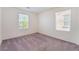 A bright bedroom features neutral walls and carpet with two sunny windows at 4610 Lime Straight Dr, Las Vegas, NV 89115