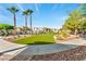 Lush green common area with walking paths, landscaping, and palm trees at 4610 Lime Straight Dr, Las Vegas, NV 89115