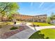 Inviting community space featuring a pergola-covered seating area, lush landscaping, and well-maintained walkways at 4610 Lime Straight Dr, Las Vegas, NV 89115